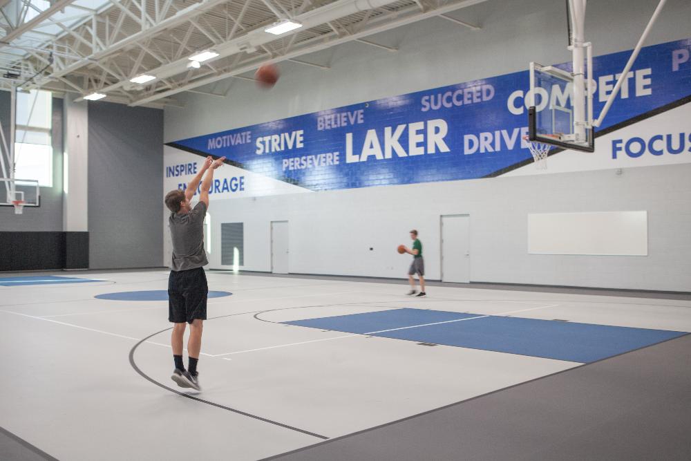 Guy shooting a jump shot on new basketball courts